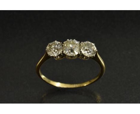 A diamond trilogy ring, linear set with three cushion and round old cut diamonds, estimated total diamond weight approx 1.50c