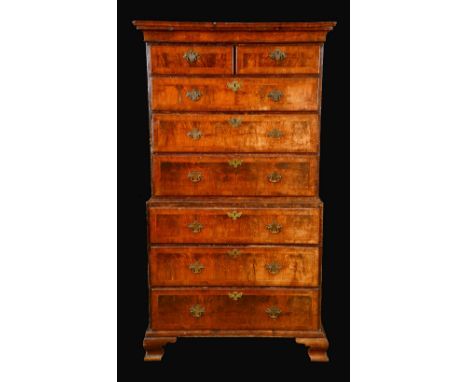 A George II walnut chest on chest, moulded top above two short and three long graduated drawers, the slightly projecting base
