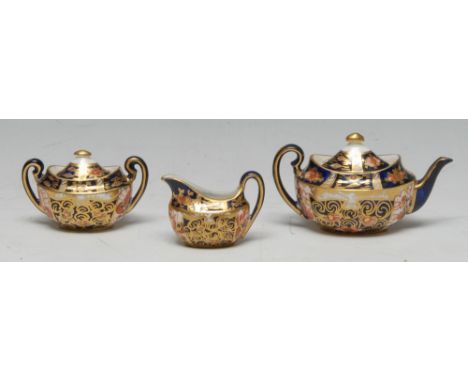 A Royal Crown Derby 1128 miniature tea service, circular box Condition Report: No repair or restoration. Displaying well but 