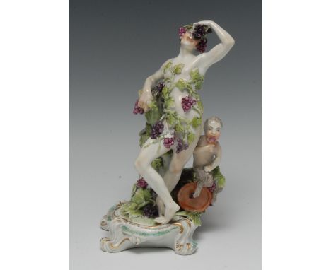 A Derby Patch Mark figure, Bacchus, standing covered in vine, holding grapes aloft, a fawn seated in a barrel, scroll base, 2