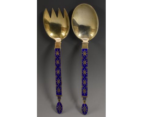 A pair of Norwegian silver and enamel servers, the stems decorated with star motifs on a deep blue ground, 18cm long, J. Tost