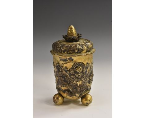 A 17th century German silver-gilt beaker and cover, bud finial, repousse chased with flowers and scrolling foliage, three bal