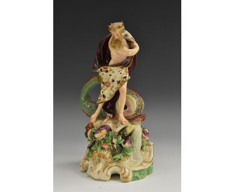 A Derby Patch Mark figure of Neptune, standing with a dolphin at his feet, holding his mantel, shell-encrusted base, 21.5cm h