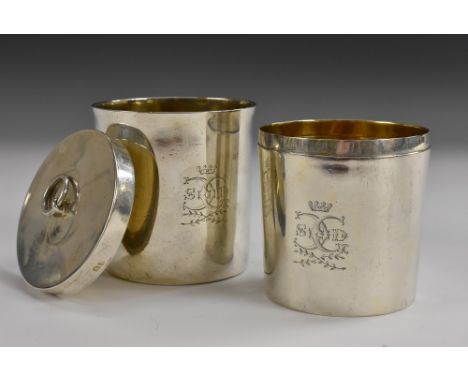 A pair of George III silver travelling beakers, stacking for storage and secured by a push-fitting cover, ring finial, gilt i