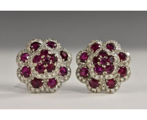 A pair of impressive Myanmar (Burma) ruby and diamond floral earrings, each inset with fourteen mixed cut rubies and seventy 