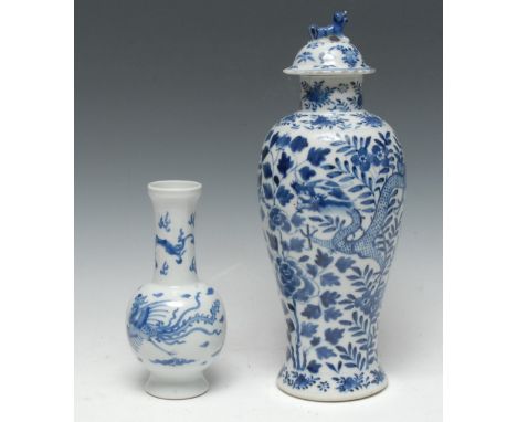 A 19th century Chinese baluster vase, decorated in underglaze blue with scrolling dragon, peonies and foliage, domed cover wi