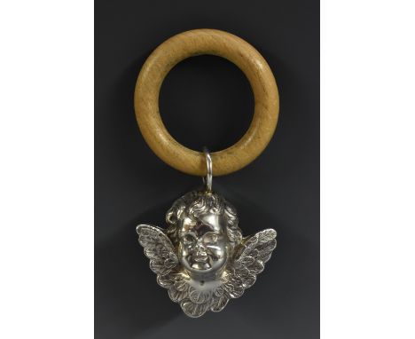 A late 19th century silver coloured metal novelty baby's rattle, as a Reynolds Angel, 10.5cm over wooden teething ring, appar