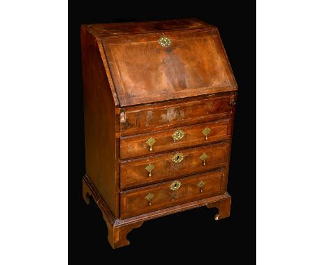 An 18th century walnut bureau, of small proportions, fall front with matched veneers enclosing a serpentine interior with sli
