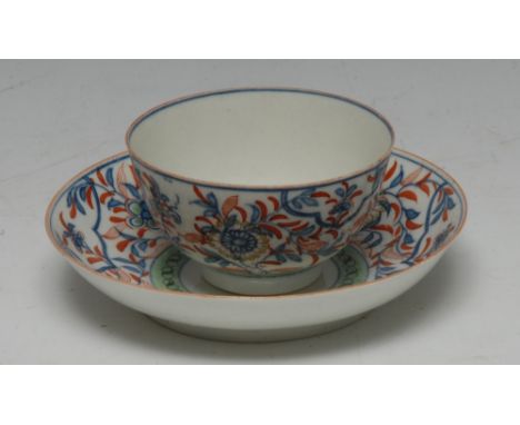 A Worcester teabowl and saucer, painted in underglaze blue overglazed iron red and green with flowers, workman's mark Conditi