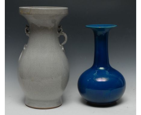 A large Chinese crackle glazed monochrome ovoid vase, lizard handles, 39cm high, 19th century (faults); a Chinese monochrome 