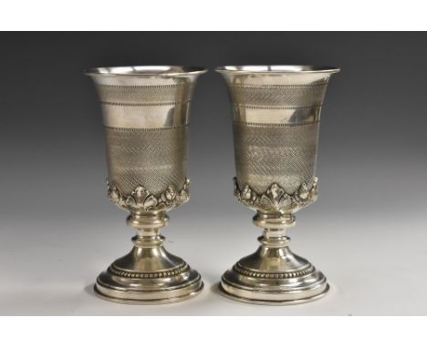 A pair Continental silver goblets, each flared and engine turned above an acanthus socle, domed foot with beaded bezel, 15.5c