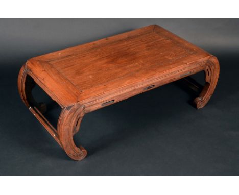 A Chinese hardwood low tea table, panel top above a pierced frieze, scroll end supports, 33cm high, 84cm wide