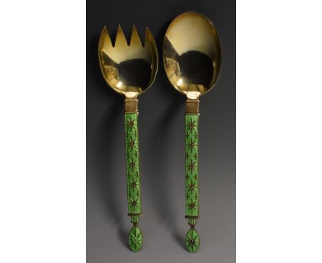 A pair of Norwegian silver-gilt and enamel servers, the stems with stylised star motifs on an apple green ground, 18cm long, 