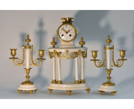 A Louis XVI style gilt metal mounted marble clock garniture, 8cm convex enamel dial with Roman numerals and swags of flowers,