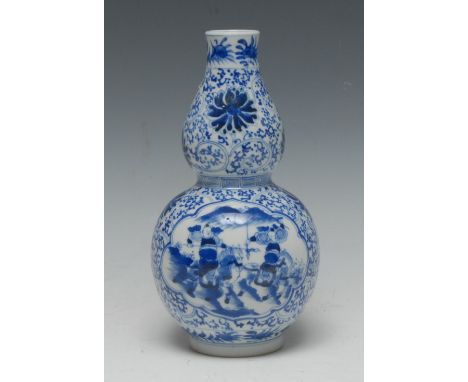 A 19th century Chinese porcelain double-gourd vase, well painted in underglaze blue with military exercises on a ground of ch