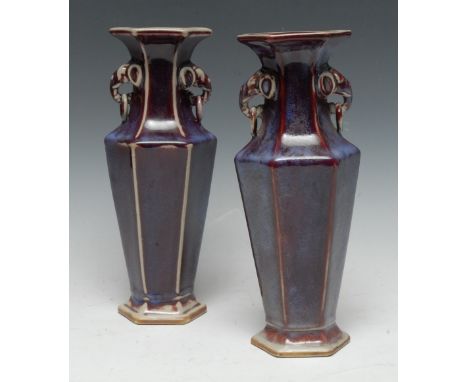 A pair of Chinese stoneware hexagonal panelled vases, glazed in merging tones of red and purple, elephant mask and ring handl