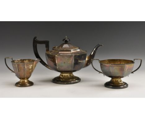 A George VI silver three-piece octagonal pedestal tea service, comprising teapot, milk jug and sugar basin, hinged cover, scr