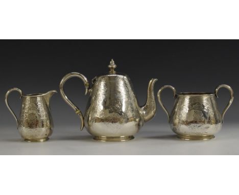 A Victorian silver ovoid three piece bachelor's tea service, comprising teapot, milk jug and sugar basin, bright-cut engraved