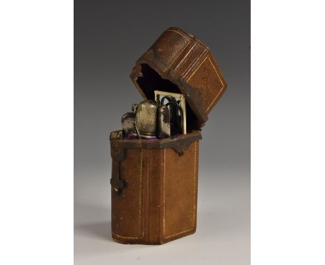 A 19th century French lady's brown morocco commode-shaped sewing etui, the hinged cover enclosing a purple velvet lined fitte