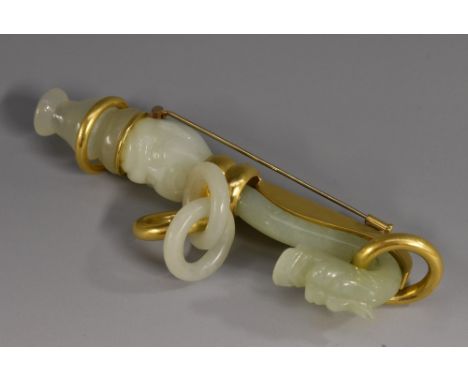 An unusual Hedy Martinelli hand crafted pale green stone and yellow metal cape/scarf adornment fastener, carved with a mask h