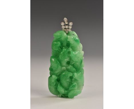 A carved jade and diamond tablet pendant, free form jade panel as leaping fish, suspended from a twelve stone brilliant and b