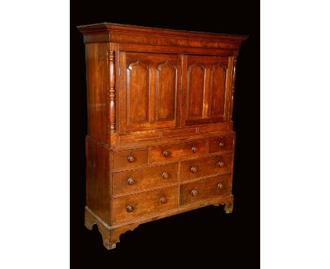 A George III Welsh oak housekeeper's press cupboard, outswept cornice above a pair of rectangular doors, each with two raised