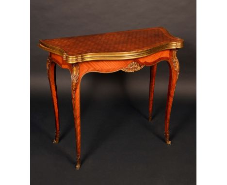 A 19th century gilt metal mounted kingwood and parquetry shaped serpentine card table, in the French Transitional taste, the 