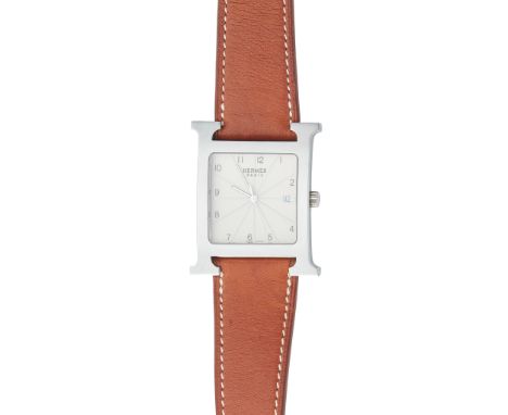 Hermes Heure H model, bold H shaped case, cream guilloche dial segmented with Arabic numerals, sweep second hand, date apertu