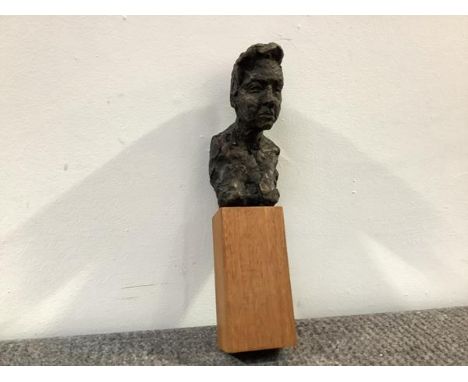 20th Century School, a small bronzed portrait bust of a man, unsigned, mounted on a wooden block. Excluding block height 14.5