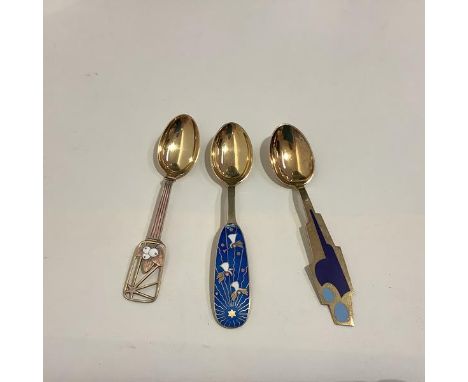 A group of three Danish sterling silver and enamel Christmas spoons by A. Michelsen, Copenhagen: 1938, the pierced handle ena