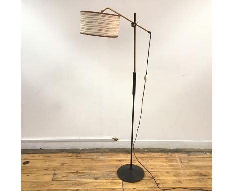 A 1950's lacquered brass, ebonised wood and steel floor lamp, stamped "DMI" and letter code, the adjustable arm on turned sha
