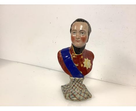 A Staffordshire pearlware bust of Tsar Alexander I, first quarter 19th century, modelled with red coat and blue sash on an in