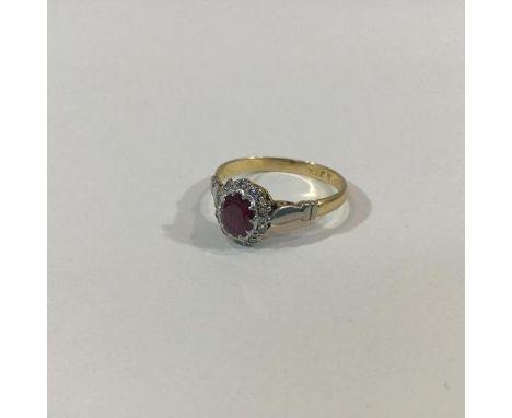 A ruby and diamond cluster ring, the oval-cut ruby claw-set within a band of ten round brilliant cut diamond points, in white