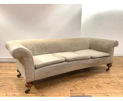 A Victorian walnut three seater sofa, the upholstered scrolling back, above three later seat cushions, upholstered in an oatm