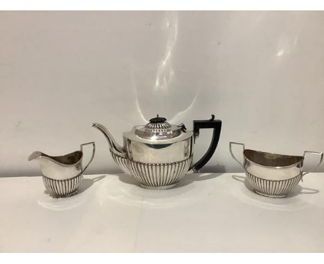 A George V silver three piece tea service, Gilbert &amp; Co., Birmingham 1913, in the Georgian style, half-reeded (hinge to t