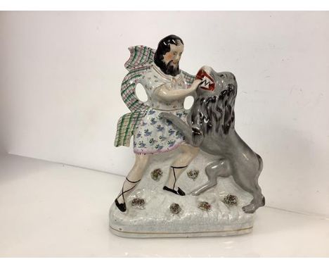 A rare Staffordshire flatback figure of Hercules and the Nemean Lion, 19th century, the lion in grey, Hercules in floral spri