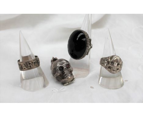 A white metal skull vinaigrette with red paste eyes, the jaw hinged to reveal a pierced grill, not hallmarked, together with 