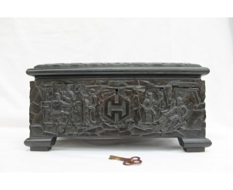 A Polish carved coal jewellery box, the top carved with a miner holding a flaming lamp and a dignitary either side of a hamme