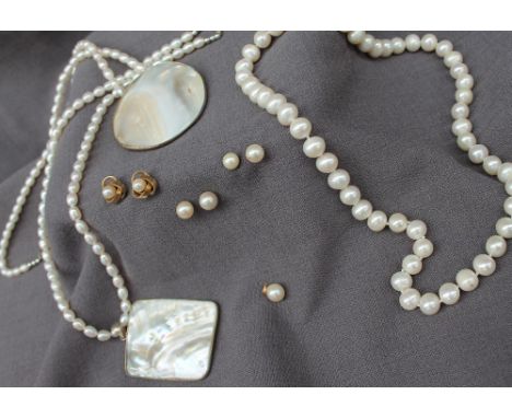 A pearl necklace with fifty-one regular pearls each approximately 8mm diameter to a 14ct gold clasp together with two other p