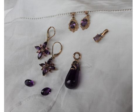 A pair of amethyst earrings of star shape to a yellow metal setting marked 9k together with another pair of amethyst earrings