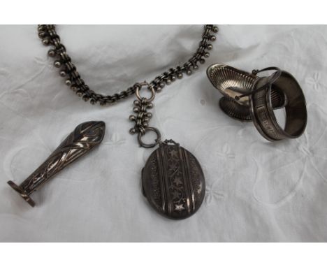 A late Victorian silver locket of oval form decorated with leaves and scrolls, Birmingham, 1884 on a white metal chain togeth