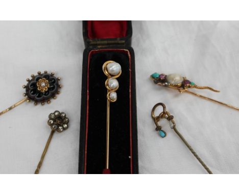 A yellow metal stick pin set with three graduated baroque Pearls, marked 14k, together with a banded agate and pearl stick pi