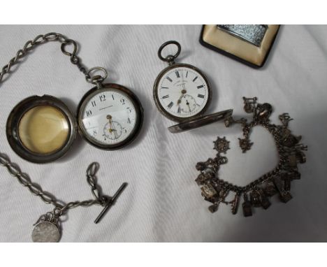 A white metal open faced pocket watch, the enamel dial with Roman numerals and a second subsidiary dial inscribed H.E.Peck, L