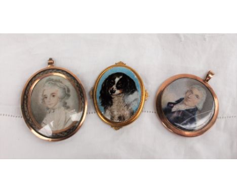 A 19th century mourning pendant / brooch, painted with a portrait miniature on ivory of a lady in a bonnet within a yellow me