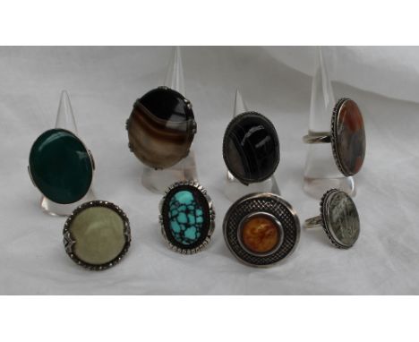 A banded agate dress ring to a white metal setting and shank together with a collection of hardstone set white metal rings