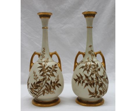 A pair of Royal Worcester twin handled vases in the Persian style, the pear shaped bodies decorated with grasses in metallic 
