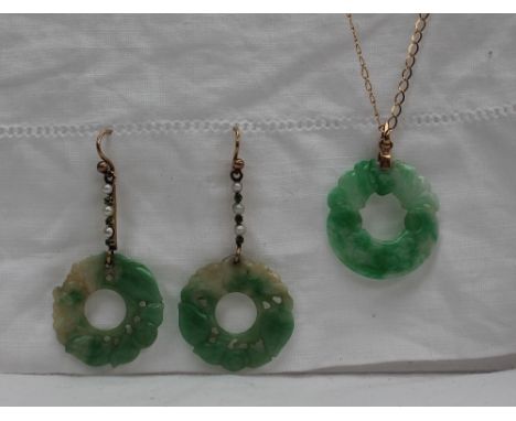 A green and white jade pendant of circular form on a yellow metal chain together with a pair of jade and pearl drop earrings 