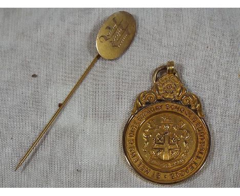 A 9ct gold hallmarked medallion marked St Helens Sunday School Football League 1930, approximate weight 6.7 grams and a gold 