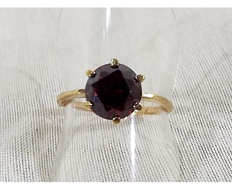 A lady's 9ct yellow gold ring set with large centre stone ruby, size O, approx weight 2.42grams, Est £40 - £60