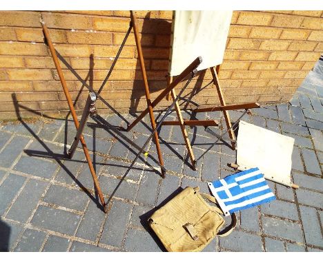 A World War Two (WWII) military canvas bag with portable tripod support chair and a small Greek flag